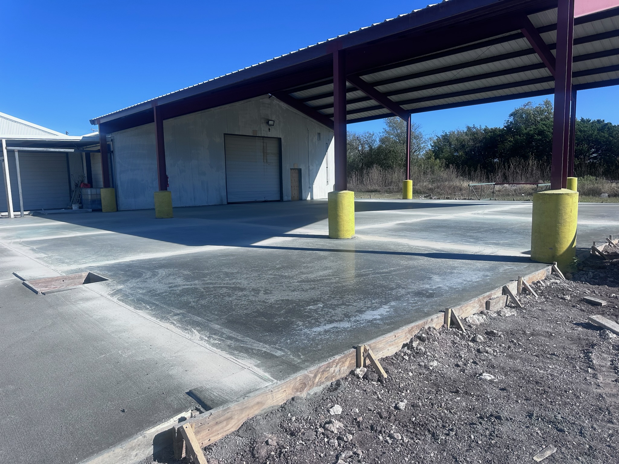 Commercial concrete flatwork around canopy columns and building access