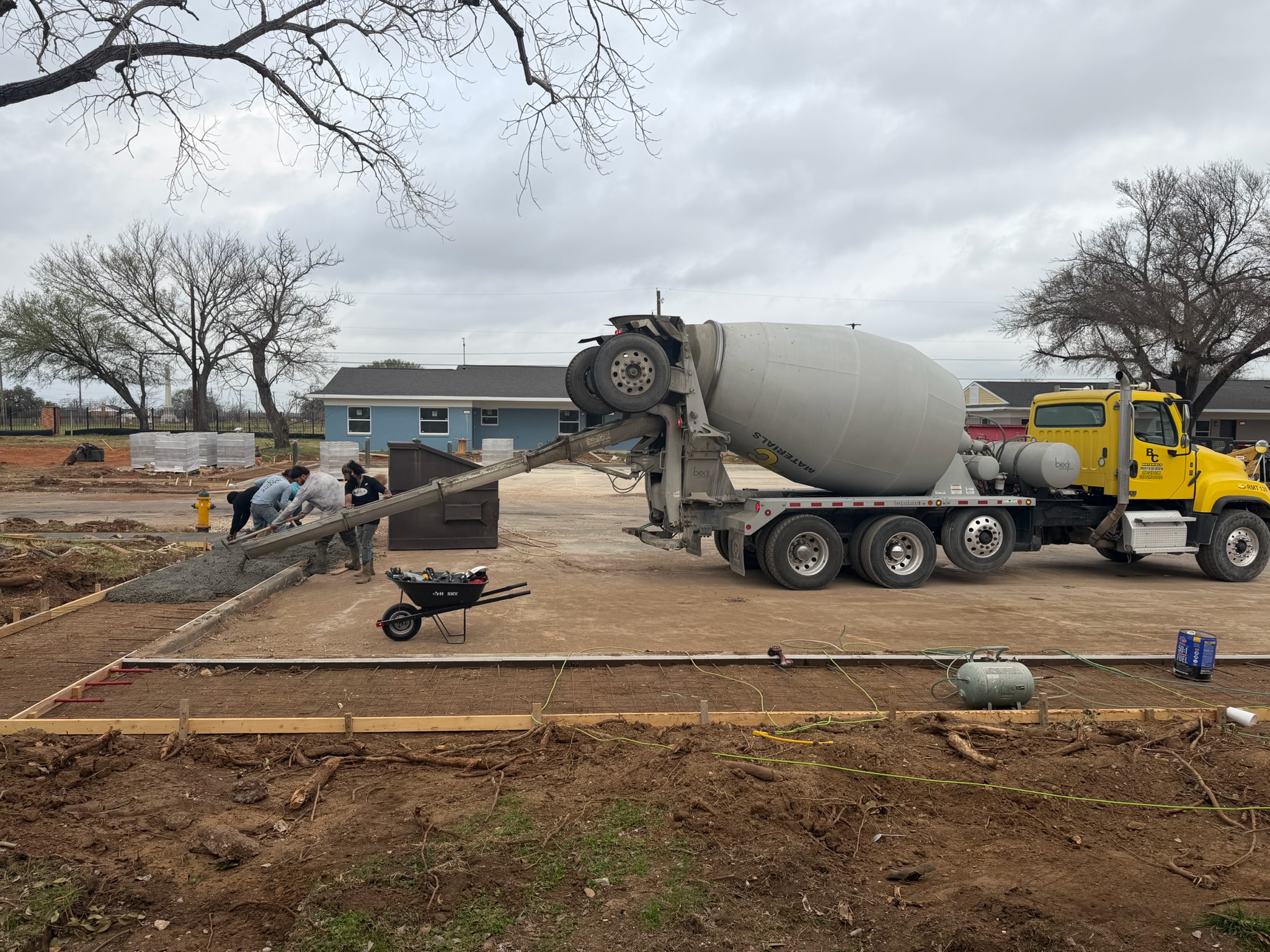 Concrete crew finishing a City of Waco sidewalk section beside the street
