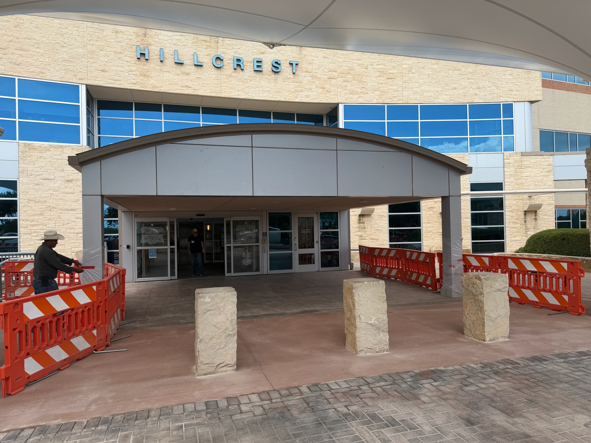 Baylor Scott & White Hillcrest front entrance concrete work with safety barriers in place