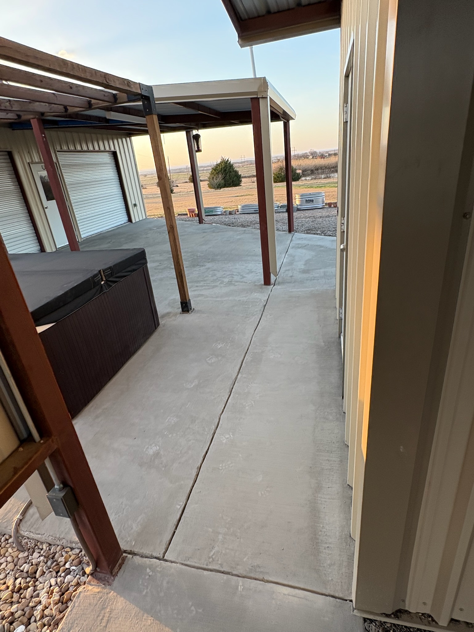 Clean concrete finish tied into a brick entry step on a Hubbard porch