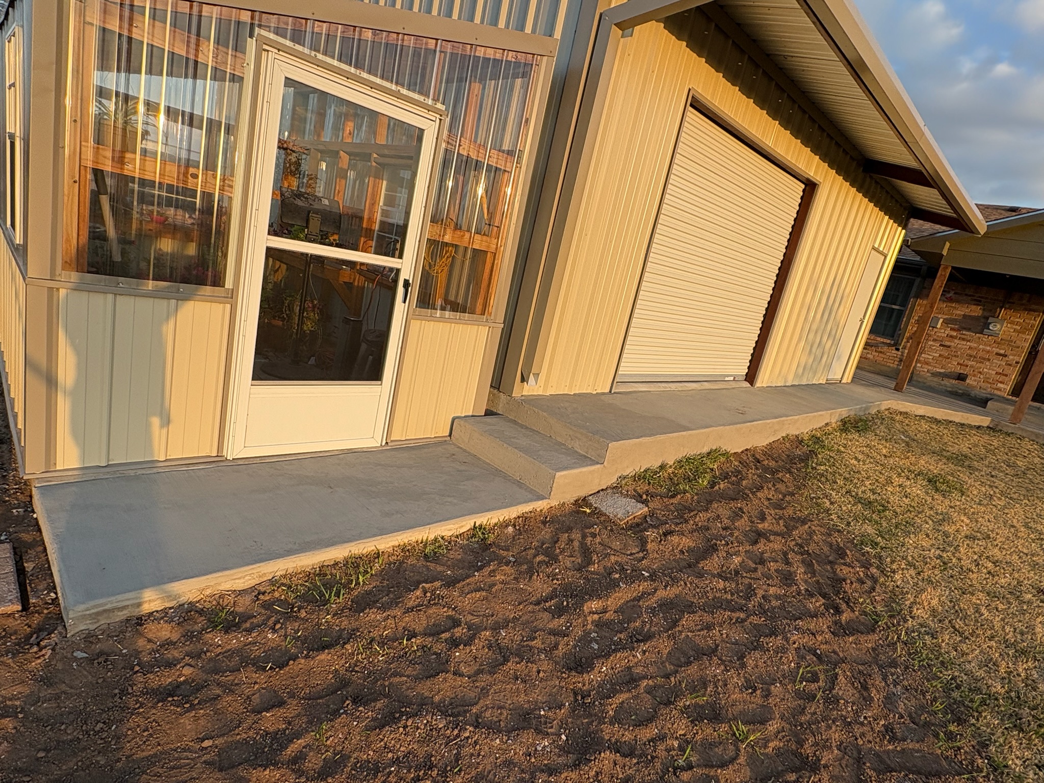 Finished concrete surface around a shop door and covered work area