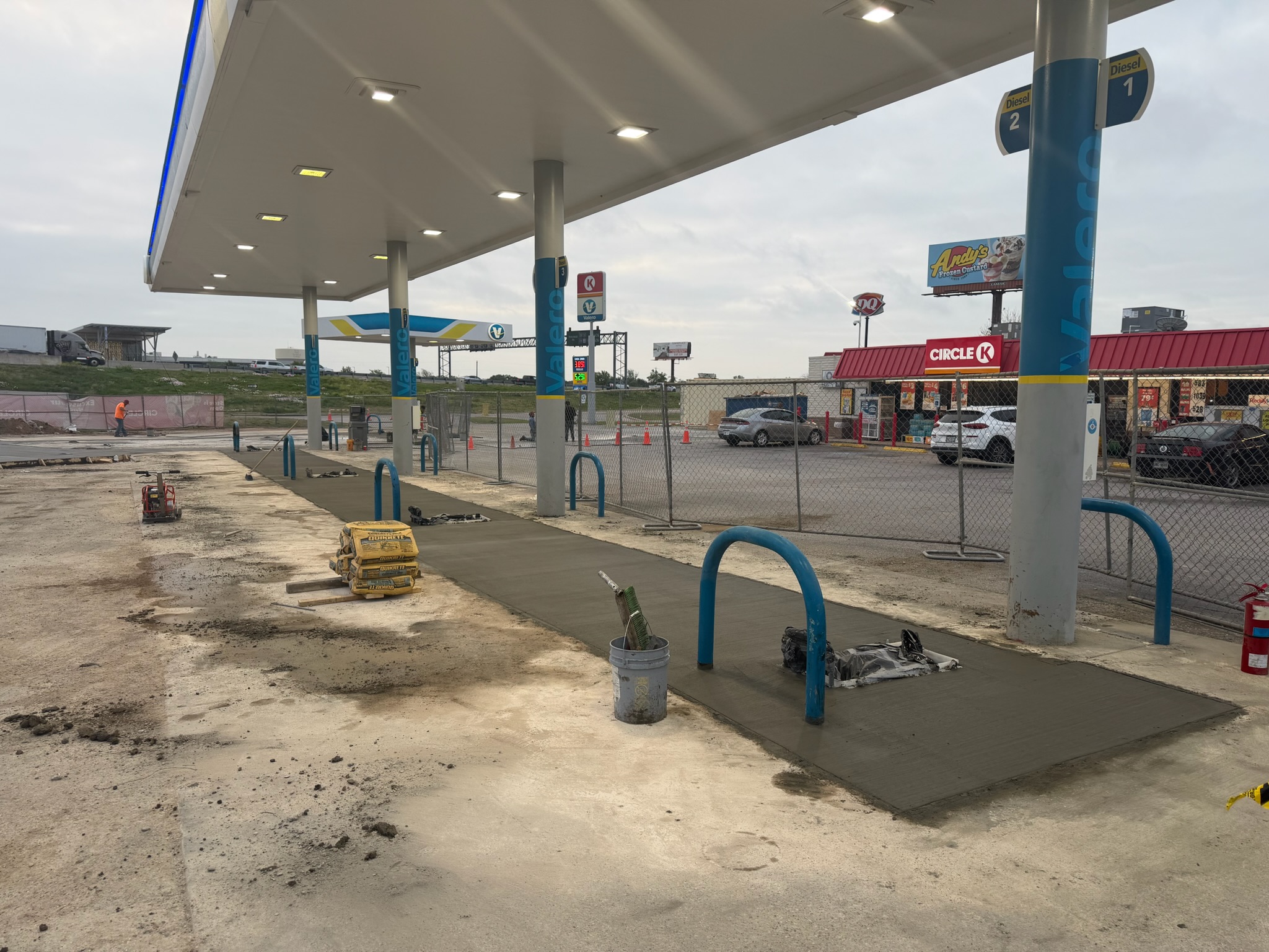 Fresh concrete flatwork under the Circle K fuel canopy in Lacy Lakeview, TX