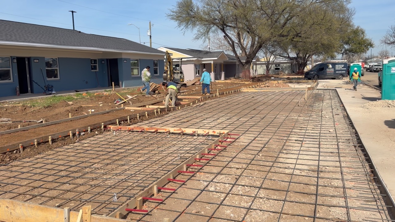 Concrete sidewalk and paving prep beside Melody Grove housing units in Waco