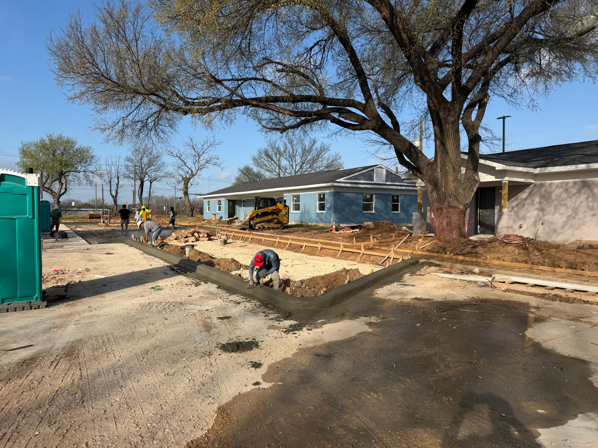 Concrete curb work and forms beside the Melody Grove parking lot pour