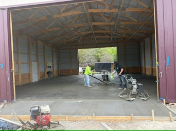 Finished concrete slab inside a Morton building shop foundation in Mount Calm, TX