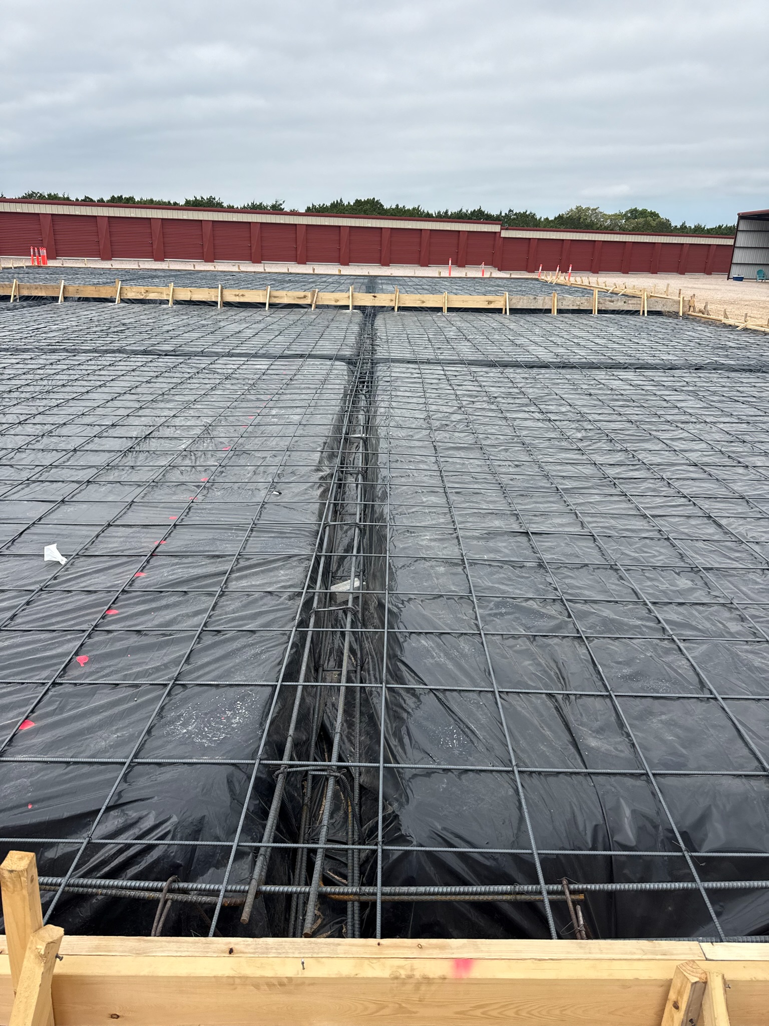 Rebar and vapor barrier ready for a Mount Calm TX shop foundation near Waco