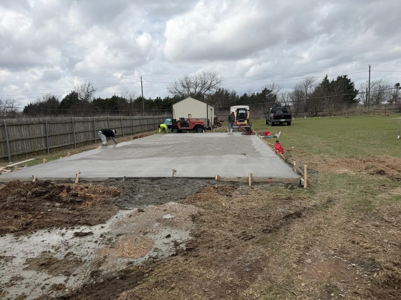 Crew finishing a fresh concrete slab in Hewitt near Waco